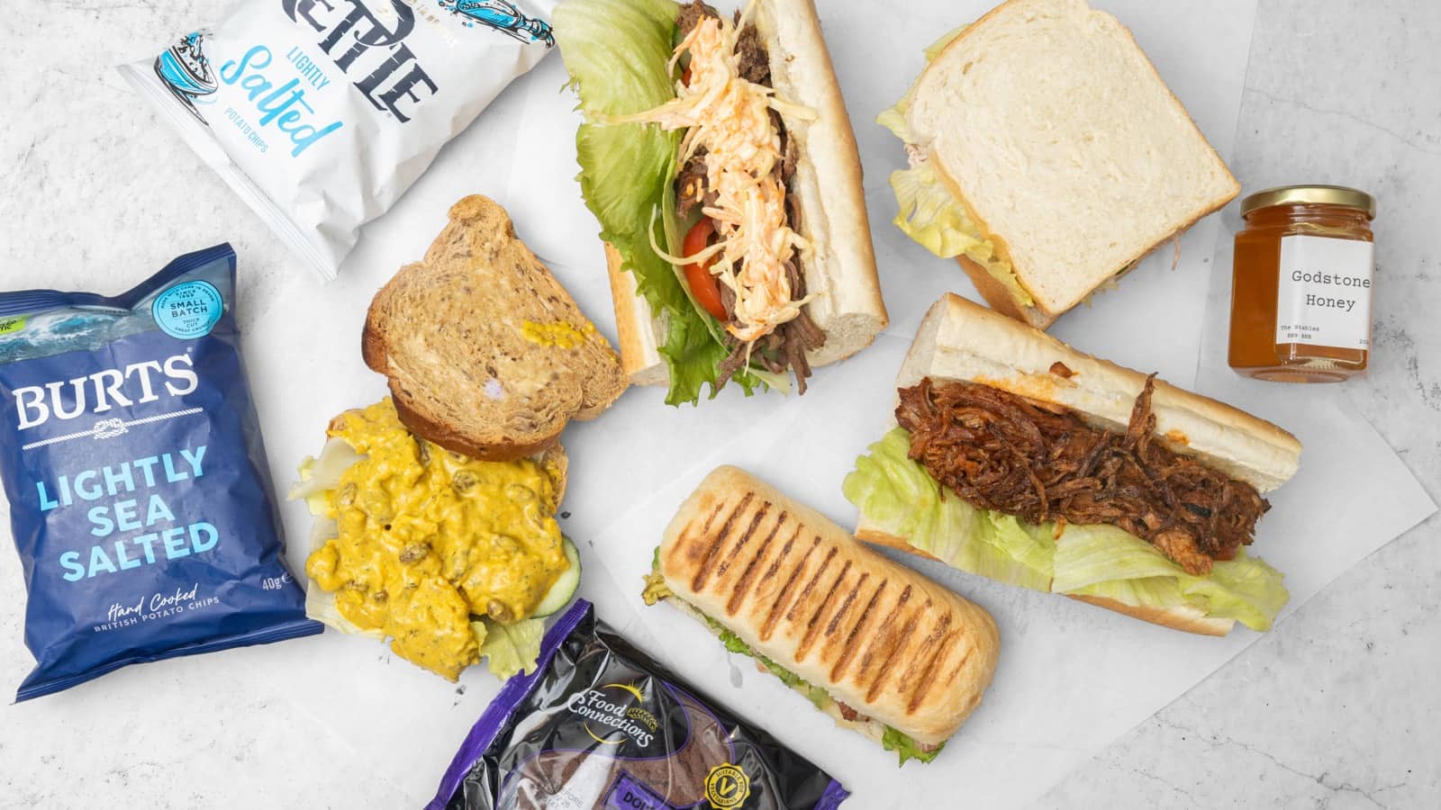 A platter of sandwiches, French sticks and a toasted panini